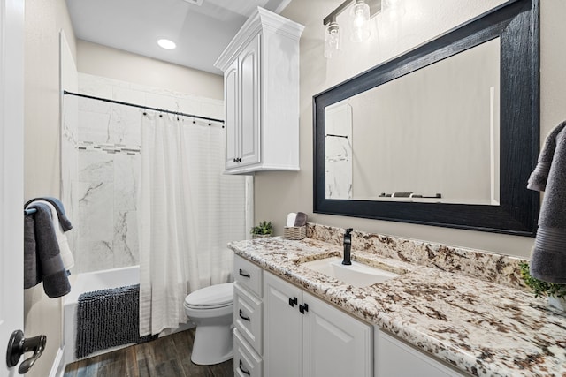 full bathroom featuring hardwood / wood-style flooring, vanity, toilet, and shower / bathtub combination with curtain