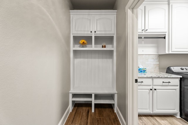 mudroom with light hardwood / wood-style floors and washer / dryer