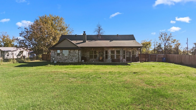 back of property featuring a yard