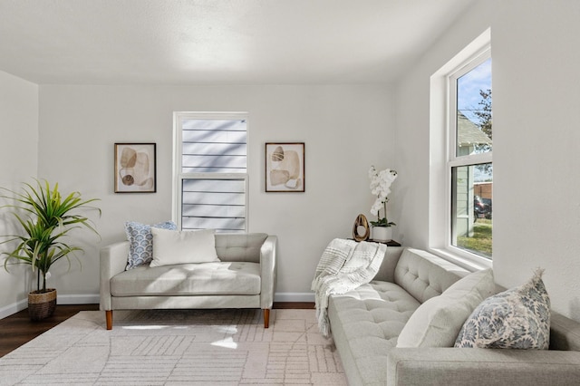 living room with light hardwood / wood-style flooring, a healthy amount of sunlight, and a textured ceiling