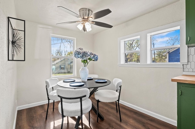 dining room with plenty of natural light, ceiling fan, and dark hardwood / wood-style flooring