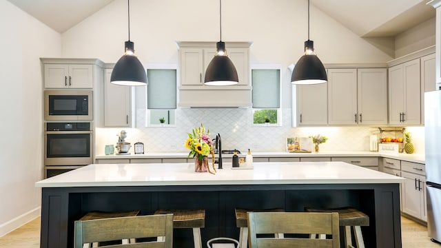 kitchen with a kitchen breakfast bar and an island with sink