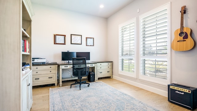 office space with plenty of natural light and light hardwood / wood-style flooring