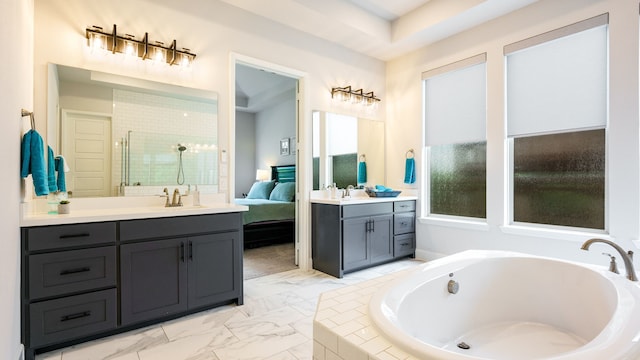 bathroom with vanity and a relaxing tiled tub