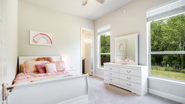 carpeted bedroom with multiple windows and ceiling fan