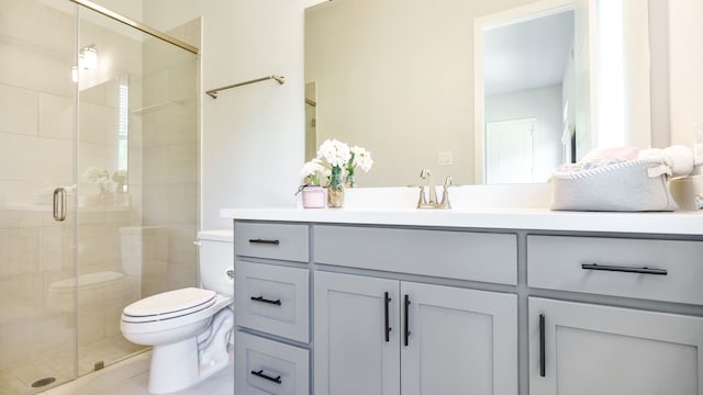 bathroom featuring vanity, toilet, and walk in shower