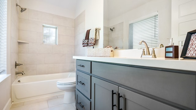 full bathroom featuring tile patterned floors, toilet, vanity, and tiled shower / bath