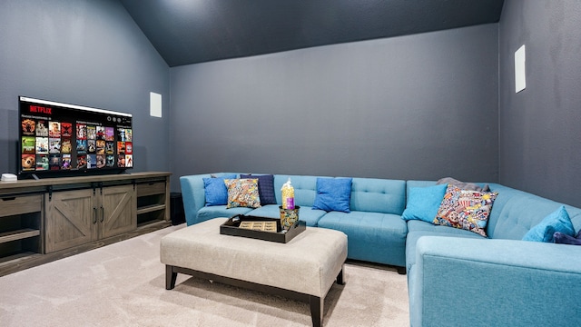 carpeted living room with lofted ceiling