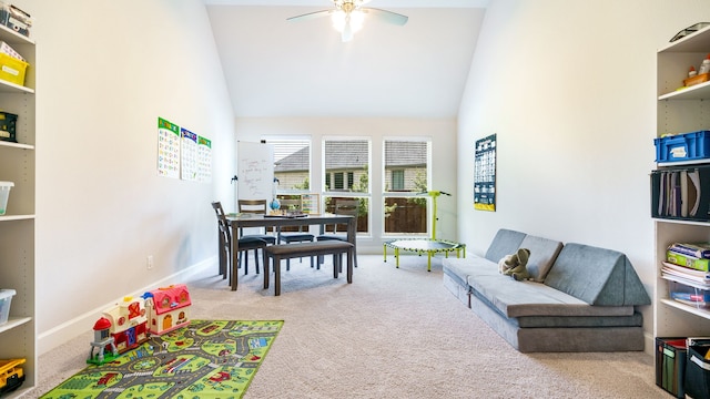 living room featuring ceiling fan, light colored carpet, and high vaulted ceiling