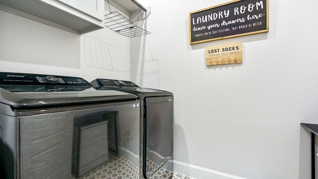 washroom featuring washer and dryer and cabinets