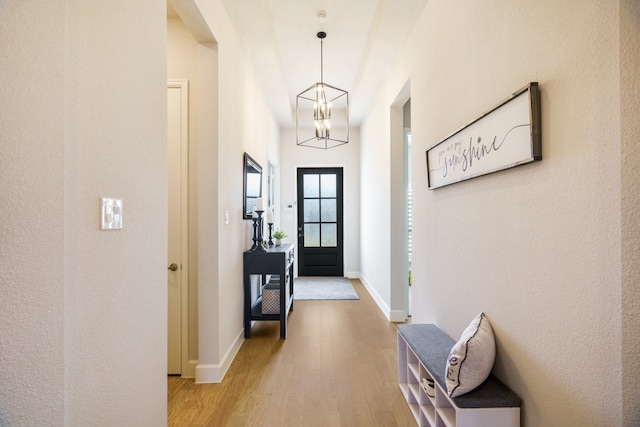 interior space featuring hardwood / wood-style floors and a chandelier