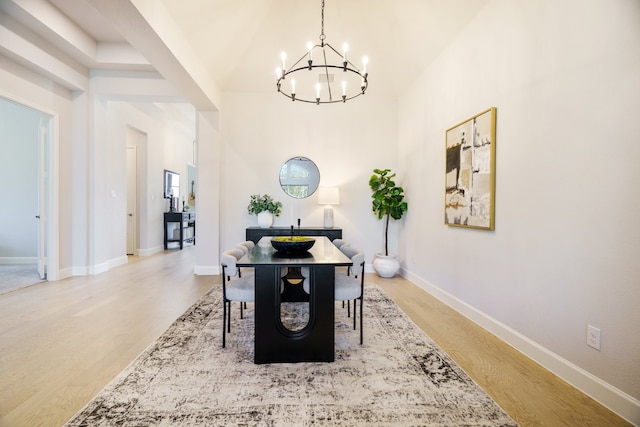 dining room with hardwood / wood-style floors and a notable chandelier