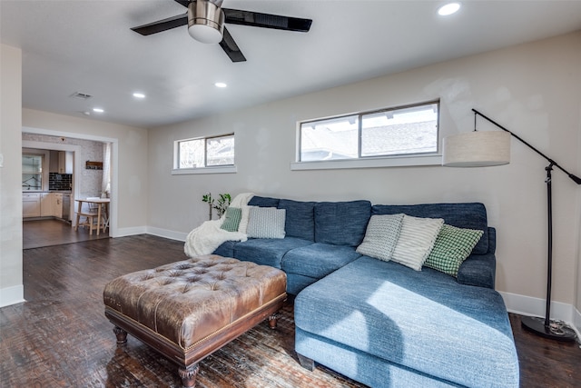 living room featuring dark hardwood / wood-style floors and ceiling fan