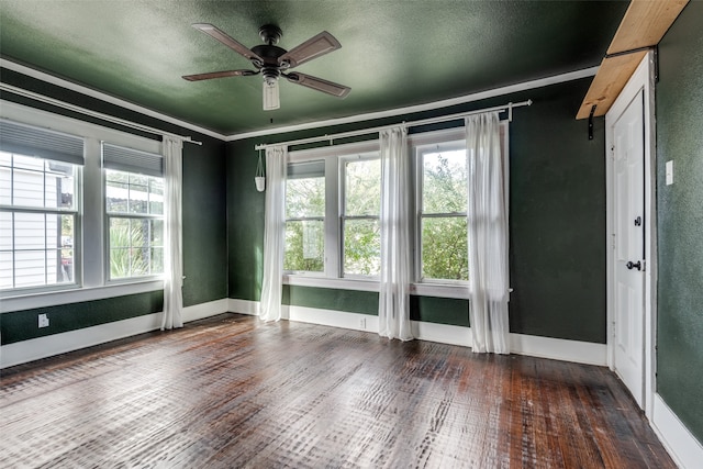 empty room with a textured ceiling, ceiling fan, and dark hardwood / wood-style floors