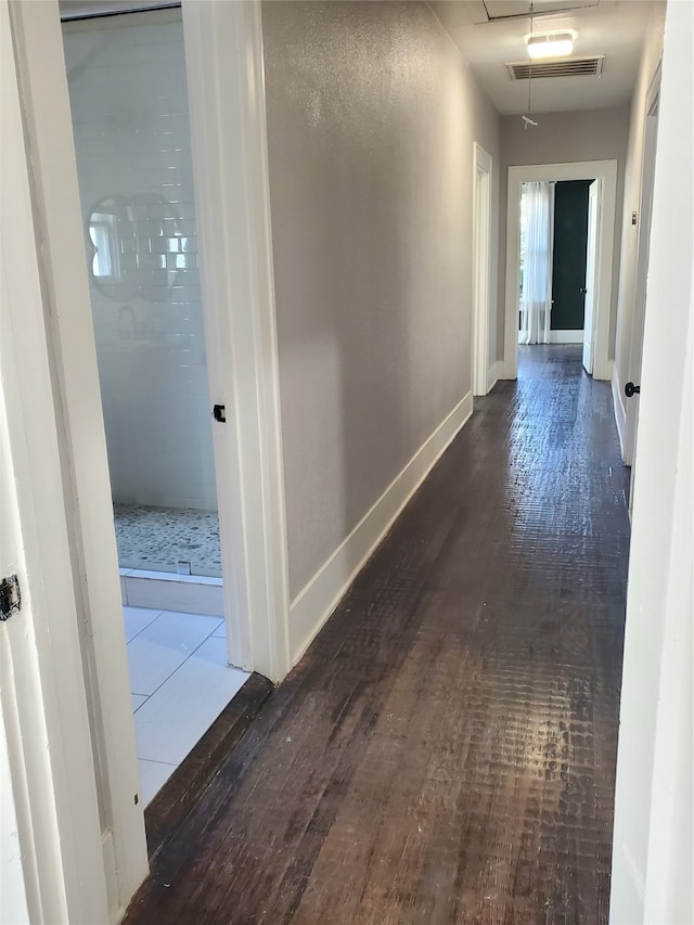 hallway featuring dark wood-type flooring