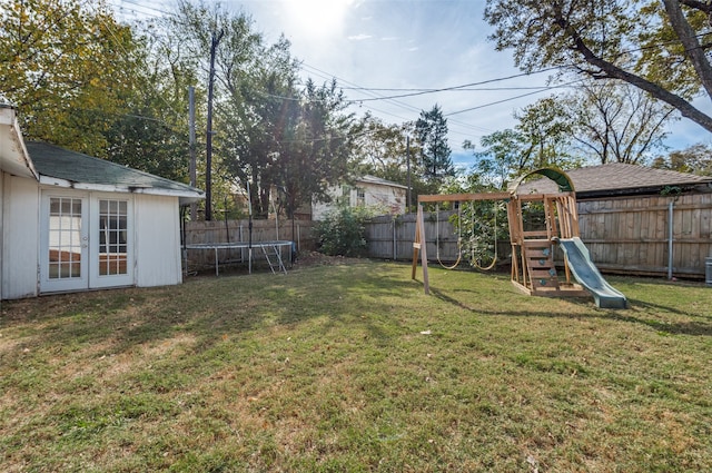 view of yard featuring a trampoline and a playground