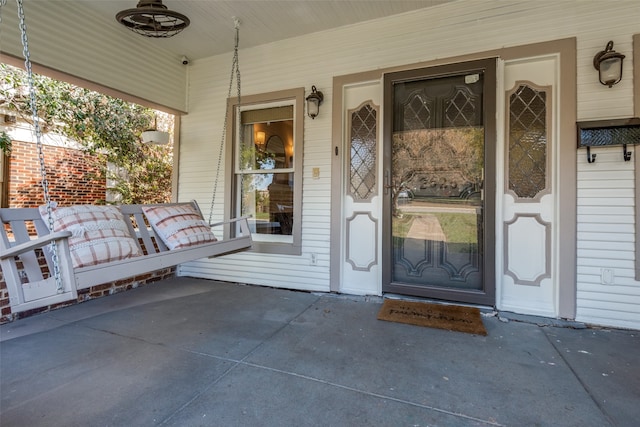 view of exterior entry featuring a porch