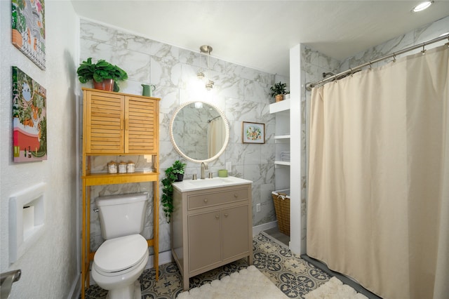 bathroom with a shower with curtain, vanity, tile walls, and toilet