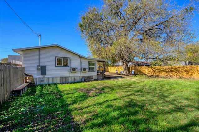 rear view of property featuring a deck and a yard