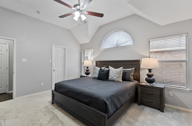 bedroom featuring light carpet, vaulted ceiling, and ceiling fan