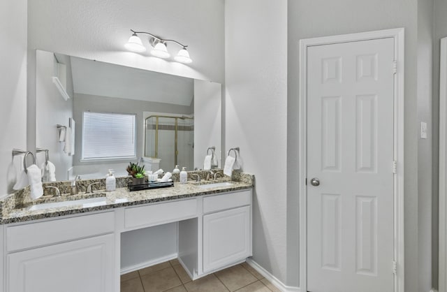 bathroom featuring tile patterned flooring, vanity, and a shower with door