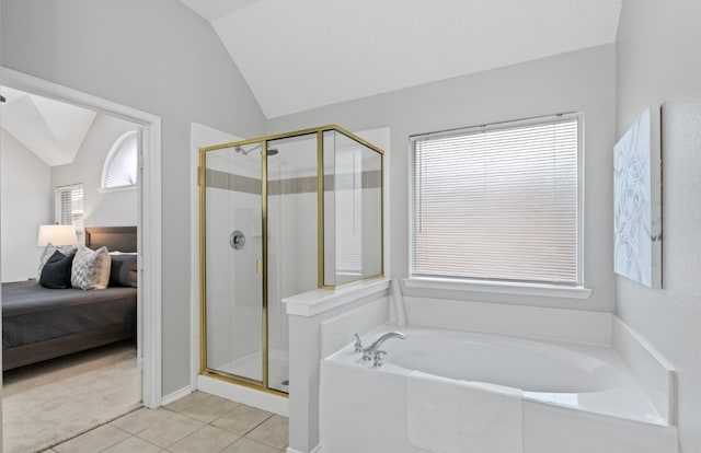 bathroom featuring lofted ceiling, tile patterned floors, and separate shower and tub