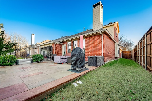 rear view of house featuring a patio and a lawn