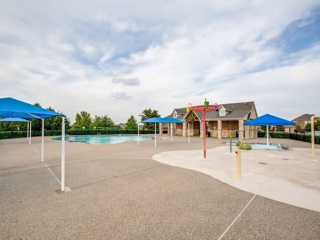 view of jungle gym with a community pool and a patio