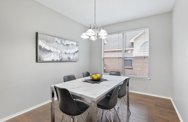 dining space with a notable chandelier and dark hardwood / wood-style flooring