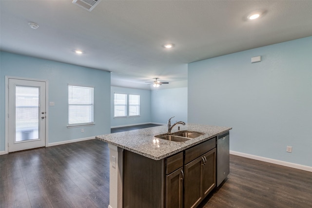 kitchen with stainless steel dishwasher, ceiling fan, dark wood-type flooring, sink, and a center island with sink