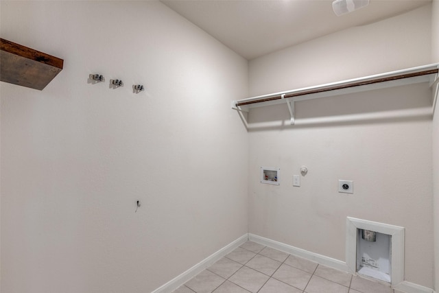 clothes washing area featuring electric dryer hookup, hookup for a gas dryer, light tile patterned floors, and washer hookup