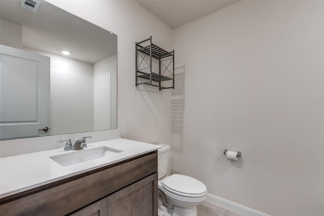 bathroom featuring tile patterned floors, vanity, and toilet