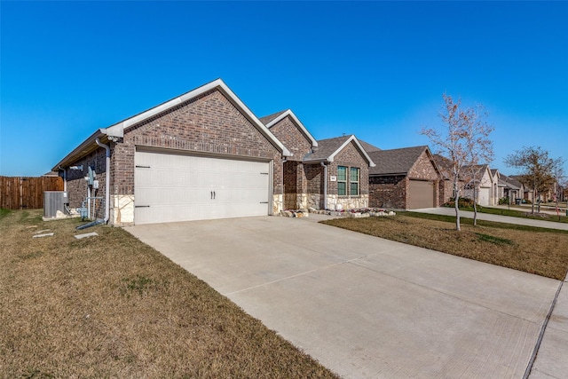 single story home with a garage, a front yard, and central air condition unit