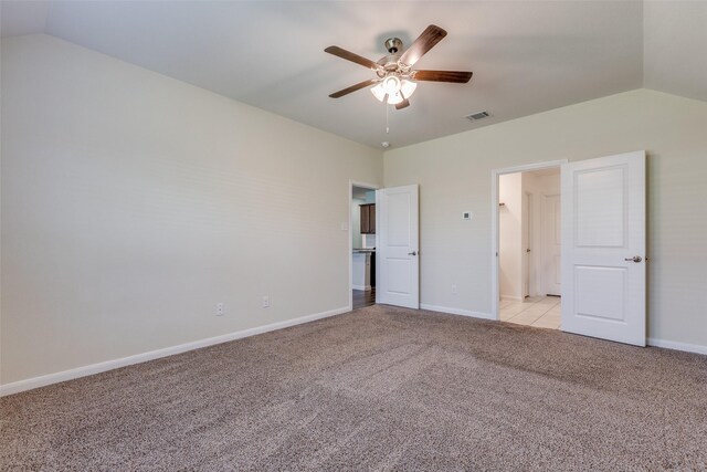 unfurnished bedroom with ceiling fan, light carpet, and vaulted ceiling