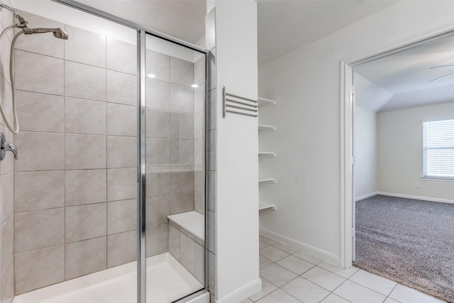 bathroom featuring tile patterned flooring, ceiling fan, and an enclosed shower