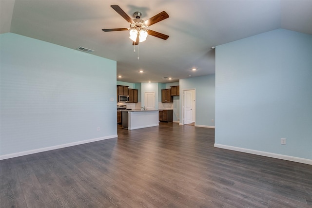 unfurnished living room featuring vaulted ceiling, ceiling fan, and dark hardwood / wood-style floors