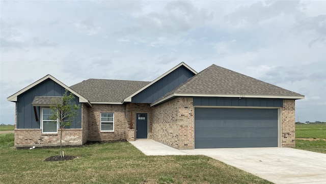 view of front of property with a front lawn and a garage