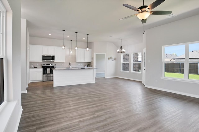 unfurnished living room featuring sink, ceiling fan with notable chandelier, and dark wood-type flooring