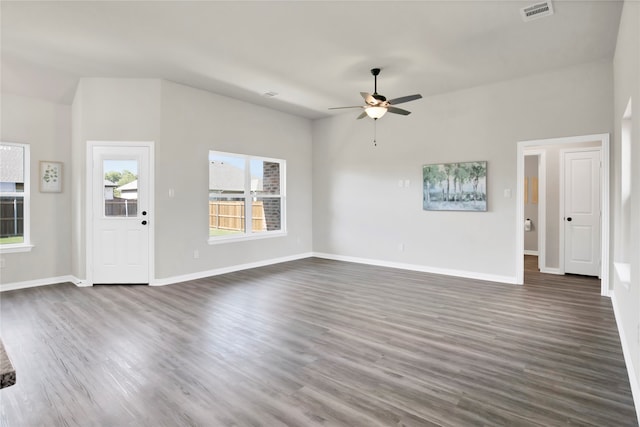 unfurnished living room featuring ceiling fan and dark wood-type flooring