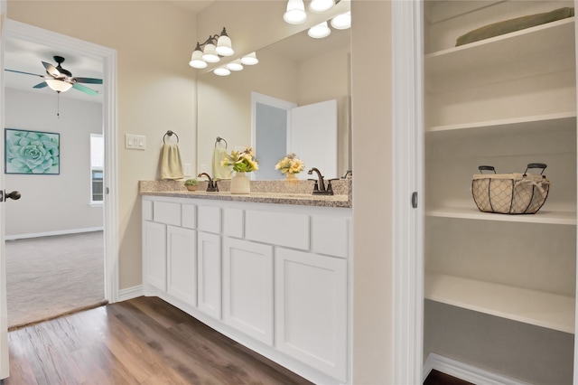 bathroom with vanity, ceiling fan, and wood-type flooring