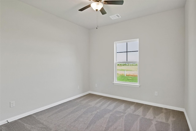 carpeted spare room featuring ceiling fan