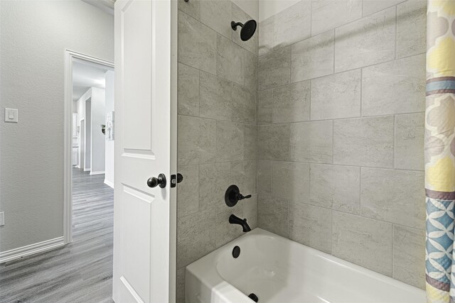 bathroom with shower / bath combination with curtain and hardwood / wood-style flooring