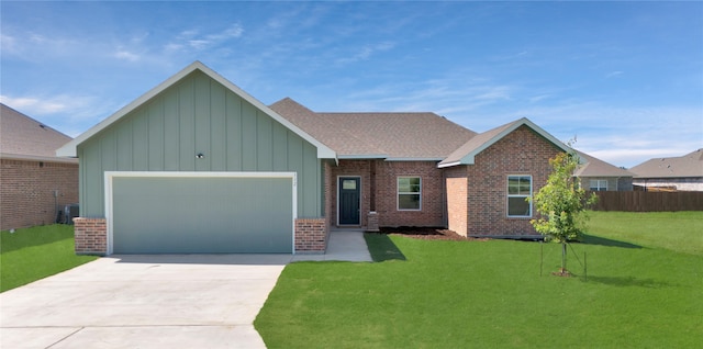 view of front of house featuring central AC unit, a garage, and a front yard