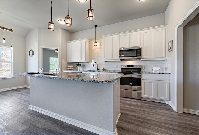 kitchen featuring backsplash, white cabinets, stainless steel appliances, and dark hardwood / wood-style floors