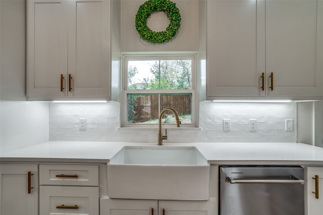 kitchen featuring decorative backsplash, sink, and stainless steel dishwasher