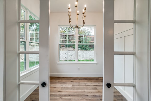 interior space with a healthy amount of sunlight and a chandelier