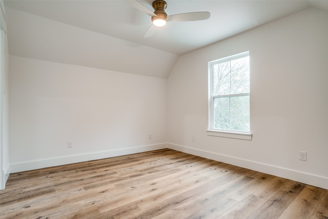 additional living space featuring ceiling fan, vaulted ceiling, and light wood-type flooring