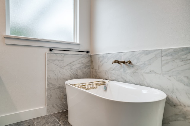 bathroom with tile walls and a bathing tub