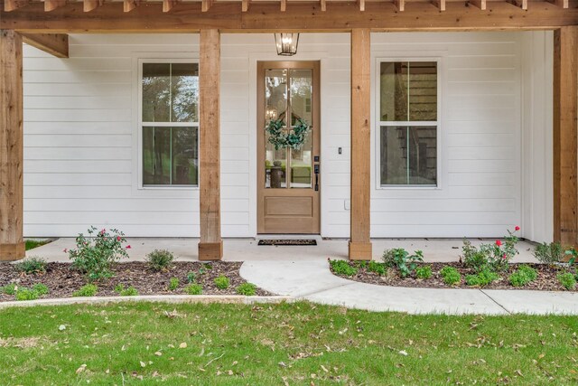 view of exterior entry featuring a porch