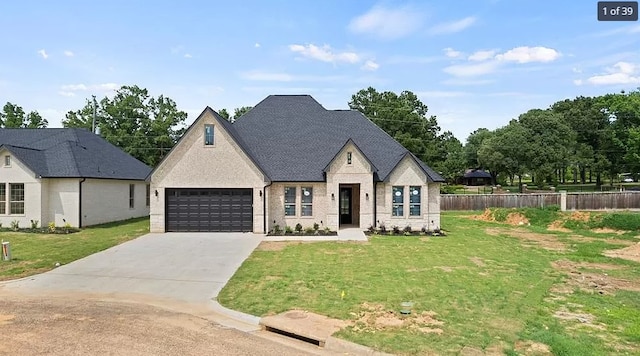 view of front of house with a garage and a front lawn